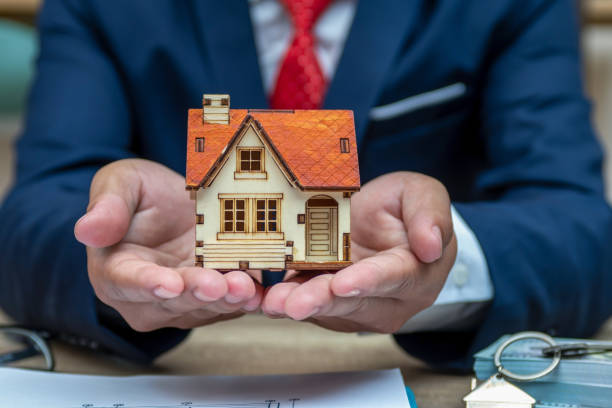 Business man hand key and house model
